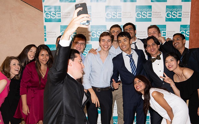 Students take a selfie at graduation