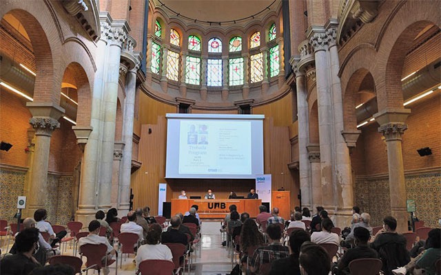 Research roundtable in a Modernist room with vaulted ceiling and stained glass windows